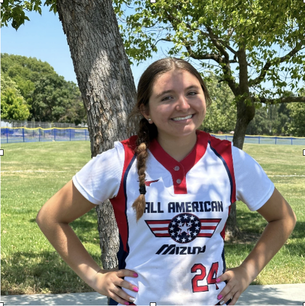 Smiling woman in 'All American' sports uniform outdoors